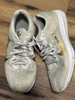 Nike Women's Athletic Sneakers in Beige with Gold Swoosh